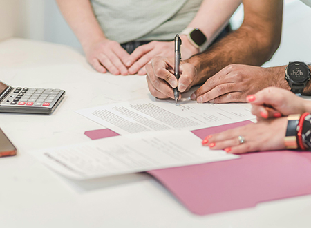 People at a table finalizing a contract