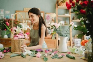 Woman standing behind the counter of her small flower shop