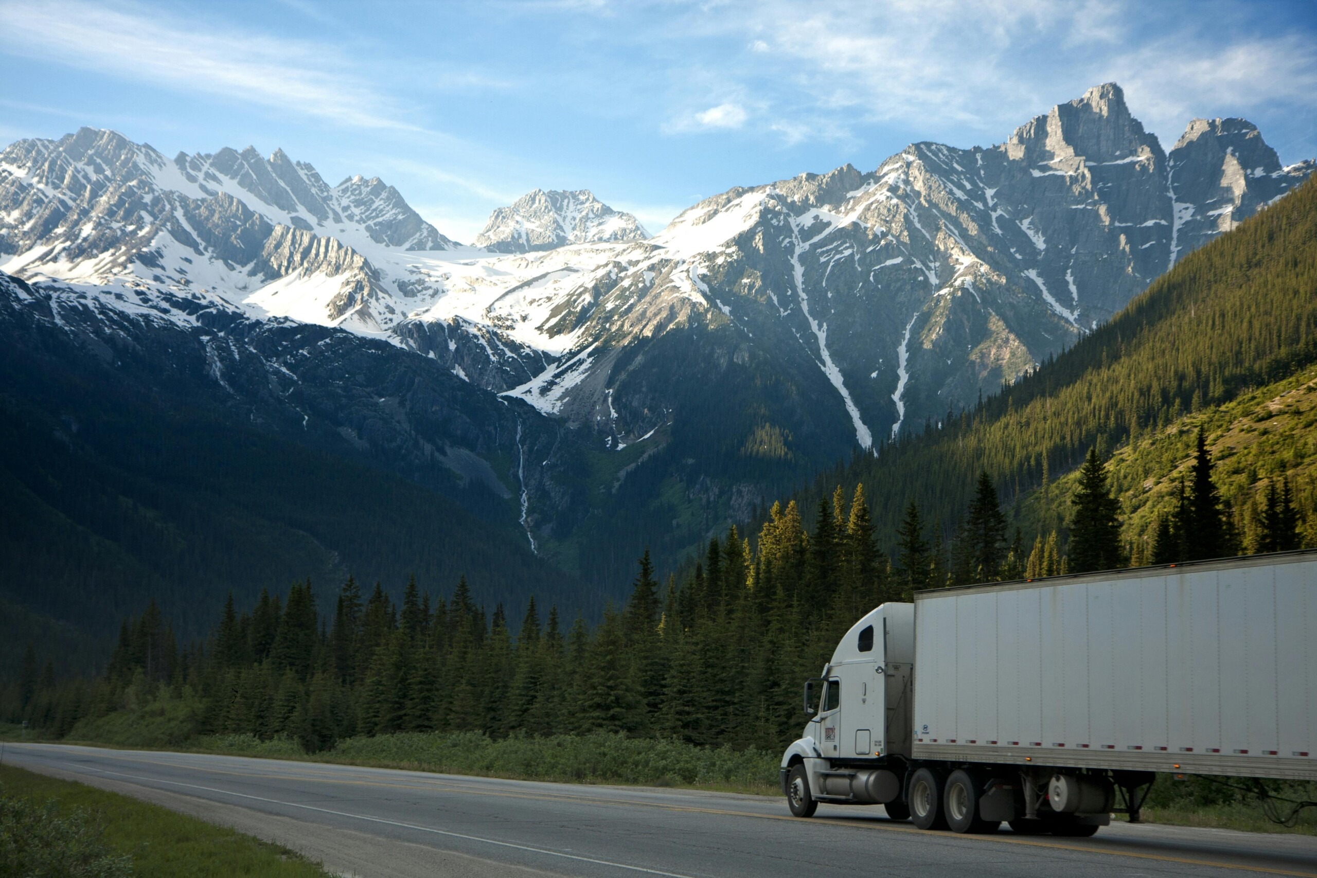 A semi truck driving through the mountains
