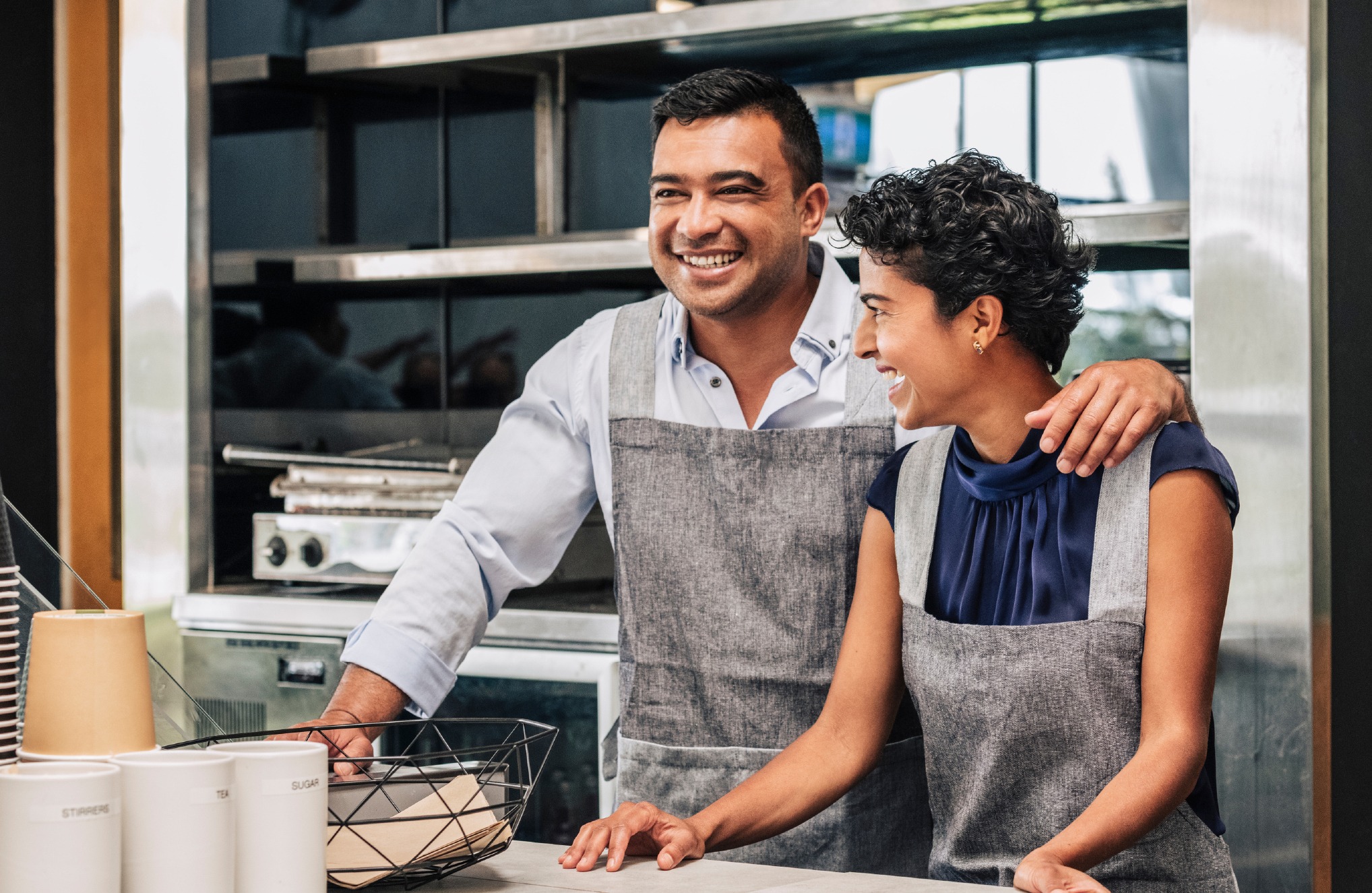 TWO HISPANIC PEOPLE AT A BAKERY